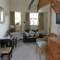 Image of the lounge in Horseshoe and Anvil self-catering cottages, The Old Forge, Wilton